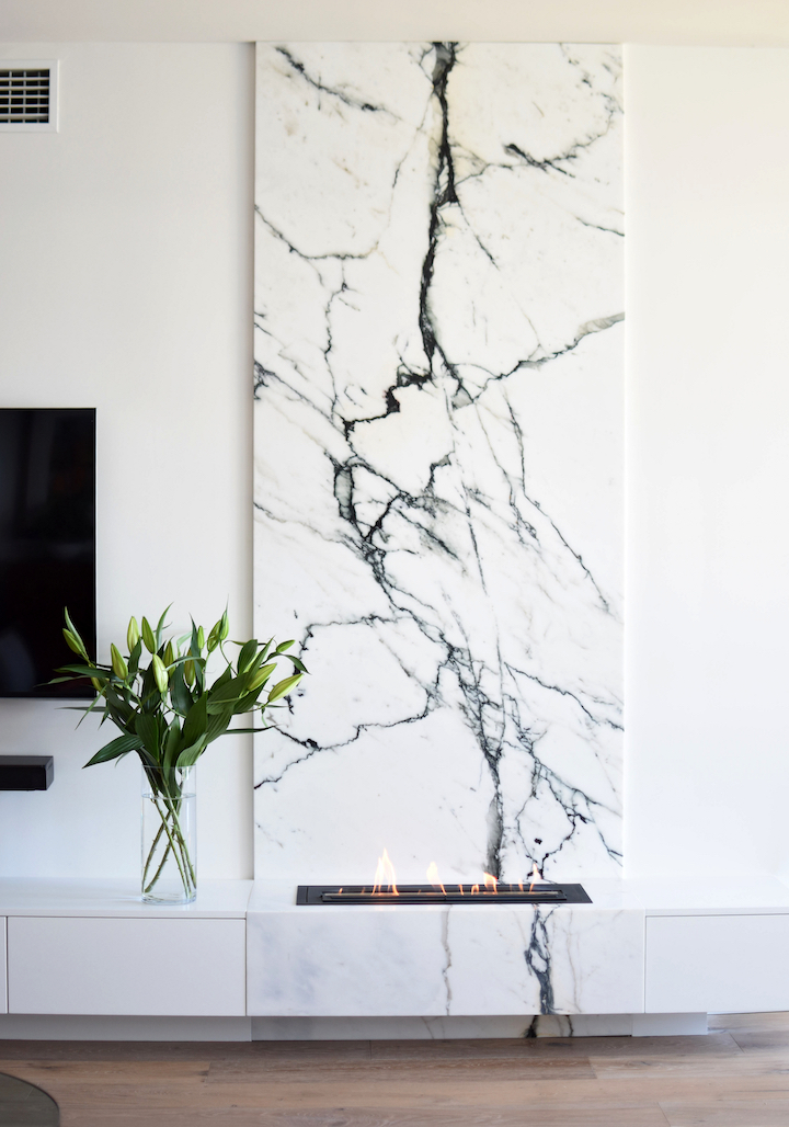 View of fireplace with backing marble.