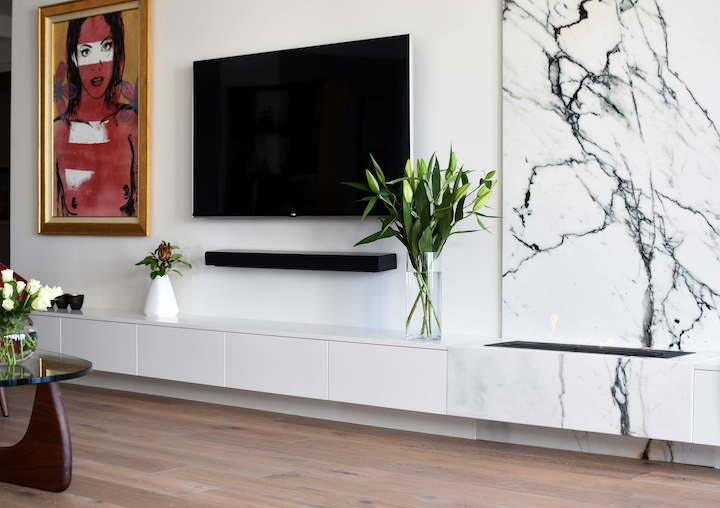 View of fireplace with backing marble.